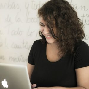 woman writing on computer